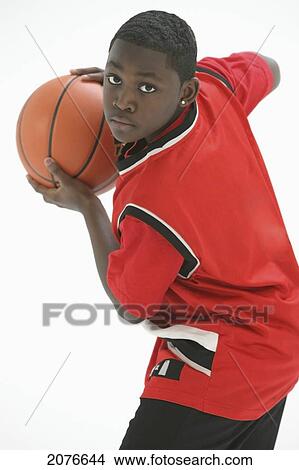 Teenage boy in red jersey ready to pass the basketball; portland oregon united states of america View Large Photo Image Picture - Teenage boy in red jersey ready to pass the basketball; portland oregon united states of america. Fotosearch