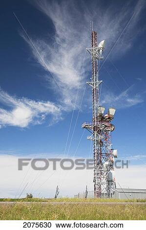 Stock Image - Telecommunications Tower In A Field With Blue Sky And Clouds; Alberta Canada. Fotosearch