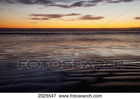 The Beach At Cox Bay Reflects The Colors Of The Sunset Near Tofino; British Columbia Canada View Large Photo Image Stock Photo - The Beach At Cox Bay Reflects The Colors Of The Sunset Near Tofino; British Columbia Canada. Fotosearch