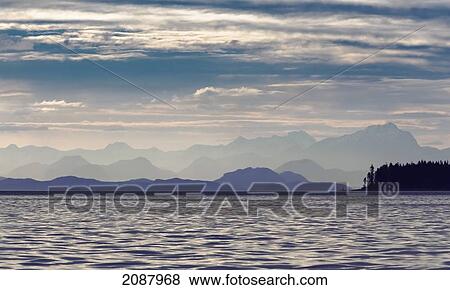 The coastal mountain range shrouded in a morning mist on the coast; british columbia canada View Large Photo Image Stock Photo - The coastal mountain range shrouded in a morning mist on the coast; british columbia canada. Fotosearch