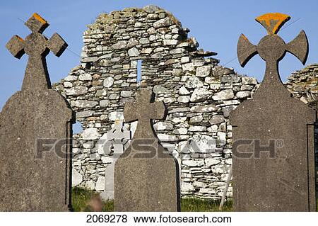 Stock Photo - Tombstones In Front Of An Old Stone Wall Near Eyeries; County Cork Ireland. Fotosearch