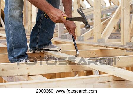 Tradesman Working On Framing For New Home Construction; St. Albert Alberta Canada View Large Photo Image Stock Image - Tradesman Working On Framing For New Home Construction; St. Albert Alberta Canada. Fotosearch
