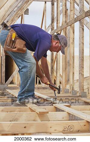 Tradesman Working On Framing For New Home Construction; St. Albert Alberta Canada View Large Photo Image Stock Image - Tradesman Working On Framing For New Home Construction; St. Albert Alberta Canada. Fotosearch
