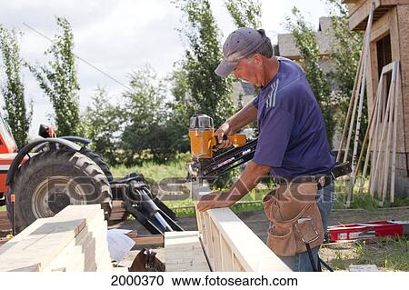 Tradesman Working On Framing For New Home Construction; St. Albert Alberta Canada View Large Photo Image Stock Image - Tradesman Working On Framing For New Home Construction; St. Albert Alberta Canada. Fotosearch