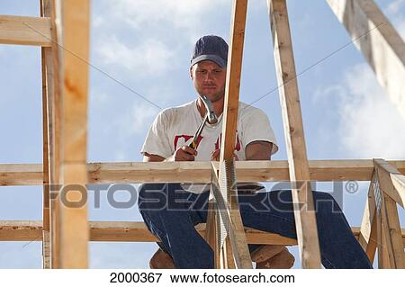 Stock Photo - Tradesman Working On Framing For New Home Construction; St. Albert Alberta Canada. Fotosearch