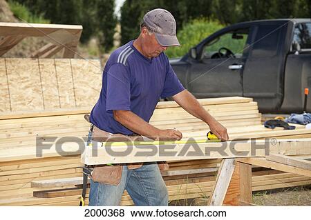 Tradesman Working On Framing For New Home Construction; St. Albert Alberta Canada View Large Photo Image Stock Photo - Tradesman Working On Framing For New Home Construction; St. Albert Alberta Canada. Fotosearch