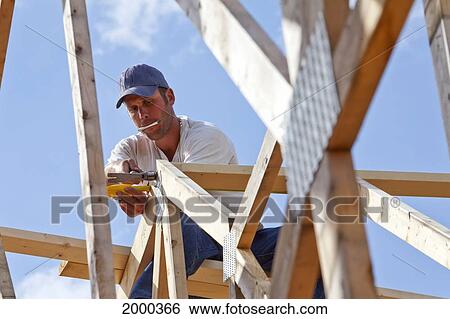 Stock Photograph - Tradesman Working On Framing For New Home Construction; St. Albert Alberta Canada. Fotosearch