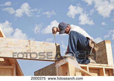 Tradesman Working On Framing For New Home Construction; St. Albert Alberta Canada View Large Photo Image Stock Photography - Tradesman Working On Framing For New Home Construction; St. Albert Alberta Canada. Fotosearch