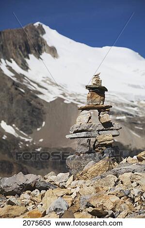 Trail Marker (Cairn) On Rocky Ridge With Glacier Capped Mountain And Blue Sky; Field British Columbia Canada View Large Photo Image Stock Photography - Trail Marker (Cairn) On Rocky Ridge With Glacier Capped Mountain And Blue Sky; Field British Columbia Canada. Fotosearch