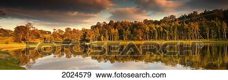Trees Lining The Water's Edge Reflected In The Water In Autumn; North Yorkshire England View Large Photo Image Stock Photo - Trees Lining The Water's Edge Reflected In The Water In Autumn; North Yorkshire England. Fotosearch