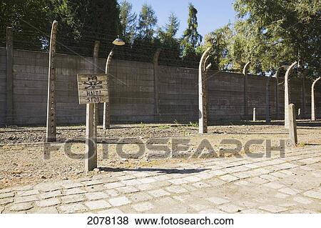 Picture - Warning sign and barb wire fences inside the auschwitz i former nazi concentration camp; auschwitz poland. Fotosearch - Search Stock Photos, Images, Print Photographs, and Photo Clip Art