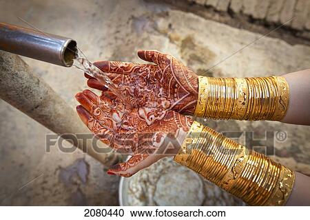 Water pouring out of a spout into palms covered with mehndi; ludhiana punjab india View Large Photo Image Stock Image - Water pouring out of a spout into palms covered with mehndi; ludhiana punjab india. Fotosearch