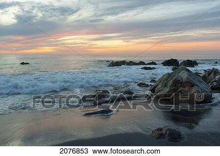 Water washing up on the beach around the rocks at sunset; sayulita mexico View Large Photo Image Stock Image - Water washing up on the beach around the rocks at sunset; sayulita mexico. Fotosearch