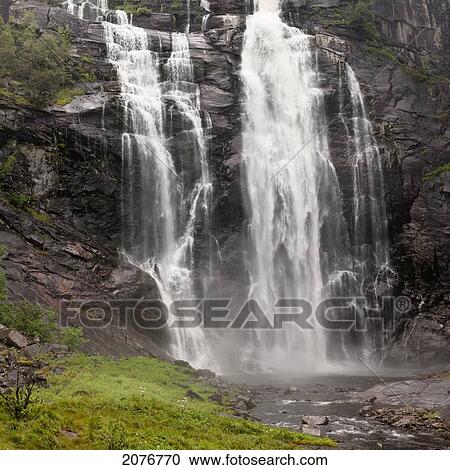 Stock Image - Waterfalls over a cliff; norway. Fotosearch