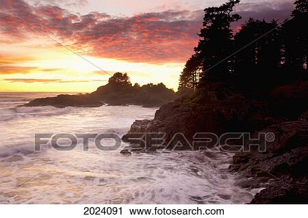 Stock Image - Waves At Cox Bay And Sunset Point At Sunset Near Tofino; British Columbia Canada. Fotosearch
