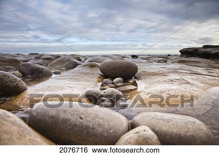 Stock Photograph - Wet rocks along the coast; south shields tyne and wear england. Fotosearch
