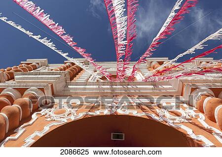 White and red streamers blowing in the wind strung above a building's doorway; guatemala city guatemala View Large Photo Image Stock Photography - White and red streamers blowing in the wind strung above a building's doorway; guatemala city guatemala. Fotosearch