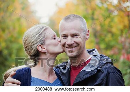 Wife Gives Husband A Kiss On The Cheek While Walking Down A Park Path In Autumn; Edmonton Alberta Canada View Large Photo Image Stock Photo - Wife Gives Husband A Kiss On The Cheek While Walking Down A Park Path In Autumn; Edmonton Alberta Canada. Fotosearch