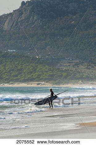 Stock Image - Windsurfer Standing On The Beach; Tarifa Cadiz Andalusia Spain. Fotosearch