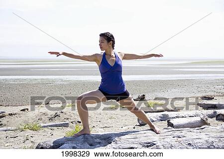 Woman Doing Yoga On A Beach; Delta British Columbia Canada View Large Photo Image Stock Photo - Woman Doing Yoga On A Beach; Delta British Columbia Canada. Fotosearch