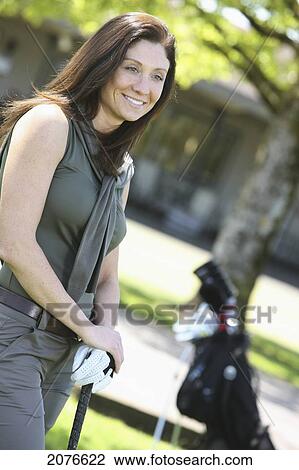 Woman standing with hands on golf clubs; troutdale oregon united states of america View Large Photo Image Stock Image - Woman standing with hands on golf clubs; troutdale oregon united states of america. Fotosearch