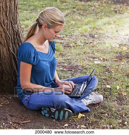 Woman Working On Netbook Computer In A Park; Edmonton Alberta Canada View Large Photo Image Stock Image - Woman Working On Netbook Computer In A Park; Edmonton Alberta Canada. Fotosearch