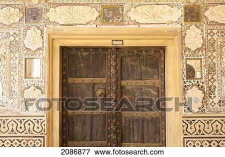 Wooden door with rivets and walls with ornate tile at amer fort; jaipur rajasthan india View Large Photo Image Stock Photo - Wooden door with rivets and walls with ornate tile at amer fort; jaipur rajasthan india. Fotosearch