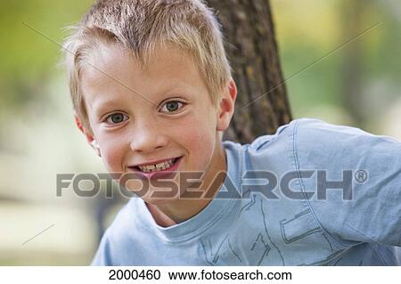 Young Boy Playing On A Tree In A Park In Autumn; Edmonton Alberta Canada View Large Photo Image Stock Image - Young Boy Playing On A Tree In A Park In Autumn; Edmonton Alberta Canada. Fotosearch