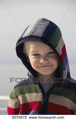 Stock Image - Young Boy Smiling With A Hood On; Delta British Columbia Canada. Fotosearch