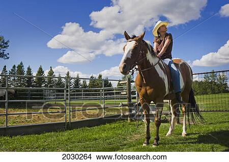 Picture - Young Cowgirl Sitting On Her Horse; Edmonton Alberta Canada. Fotosearch