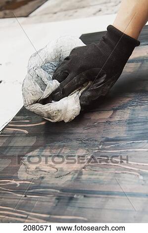 Stock Image - Young female art student creating prints in studio; edmonton alberta canada. Fotosearch