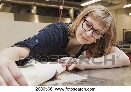 Young female art student creating prints in studio; edmonton alberta canada View Large Photo Image Stock Photograph - Young female art student creating prints in studio; edmonton alberta canada. Fotosearch