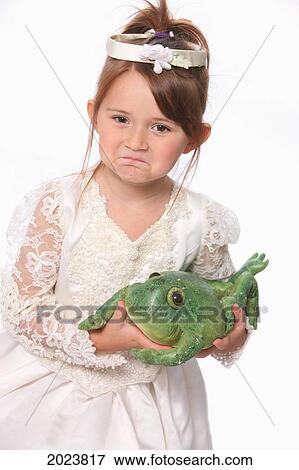 Stock Photo - Young Girl In White Princess Dress Holding A Green Frog; Troutdale Oregon United States Of America. Fotosearch