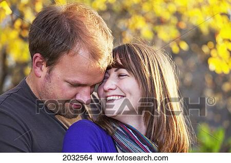 Picture - Young Married Couple Embracing In A Park; Edmonton Alberta Canada. Fotosearch