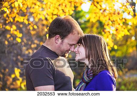 Stock Image - Young Married Couple Embracing In A Park; Edmonton Alberta Canada. Fotosearch