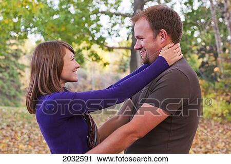 Young Married Couple Embracing In A Park In Autumn; Edmonton Alberta Canada View Large Photo Image Stock Image - Young Married Couple Embracing In A Park In Autumn; Edmonton Alberta Canada. Fotosearch