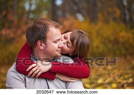 Stock Photo - Young Married Couple Embracing Intimately In A Park In Autumn; Edmonton Alberta Canada. Fotosearch