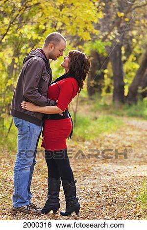 Young Married Couple In An Embrace In A Park In Autumn; Edmonton Alberta Canada View Large Photo Image Stock Photograph - Young Married Couple In An Embrace In A Park In Autumn; Edmonton Alberta Canada. Fotosearch