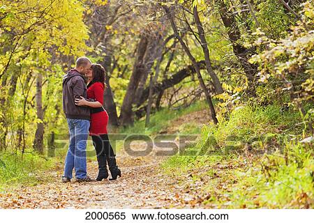 Young Married Couple Kissing While Walking In A Park In Autumn; Edmonton Alberta Canada View Large Photo Image Stock Photography - Young Married Couple Kissing While Walking In A Park In Autumn; Edmonton Alberta Canada. Fotosearch