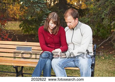Young Married Couple Praying Together On A Park Bench; Edmonton Alberta Canada View Large Photo Image Stock Image - Young Married Couple Praying Together On A Park Bench; Edmonton Alberta Canada. Fotosearch