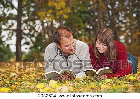 Young Married Couple Reading In A Park In Autumn; Edmonton Alberta Canada View Large Photo Image Picture - Young Married Couple Reading In A Park In Autumn; Edmonton Alberta Canada. Fotosearch