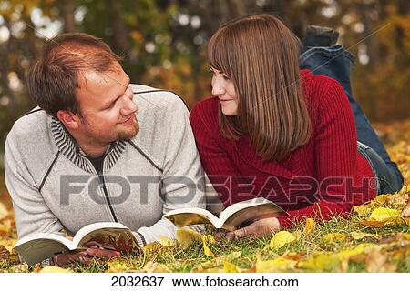 Young Married Couple Reading In A Park In Autumn; Edmonton Alberta Canada View Large Photo Image Stock Photo - Young Married Couple Reading In A Park In Autumn; Edmonton Alberta Canada. Fotosearch