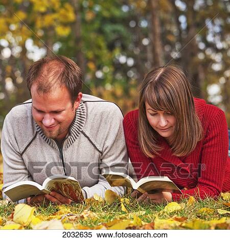 Young Married Couple Reading In A Park In Autumn; Edmonton Alberta Canada View Large Photo Image Stock Photography - Young Married Couple Reading In A Park In Autumn; Edmonton Alberta Canada. Fotosearch