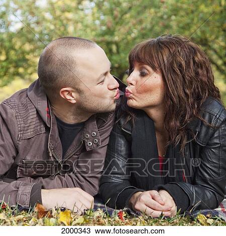 Stock Image - Young Married Couple Ready To Kiss In The Park; Edmonton Alberta Canada. Fotosearch