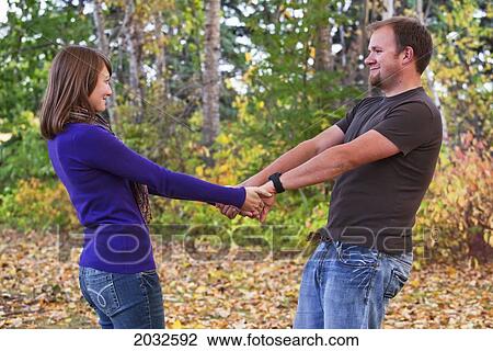 Young Married Couple Spending Quality Time Together In A Park In Autumn; Edmonton Alberta Canada View Large Photo Image Stock Image - Young Married Couple Spending Quality Time Together In A Park In Autumn; Edmonton Alberta Canada. Fotosearch