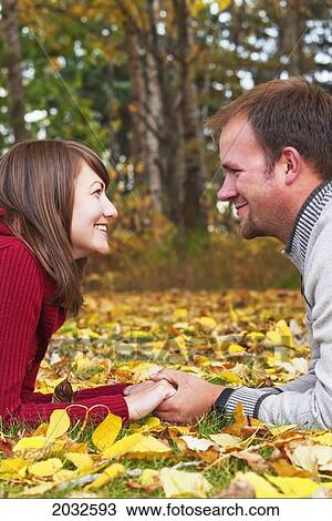 Young Married Couple Spending Quality Time Together In A Park In Autumn; Edmonton Alberta Canada View Large Photo Image Stock Image - Young Married Couple Spending Quality Time Together In A Park In Autumn; Edmonton Alberta Canada. Fotosearch