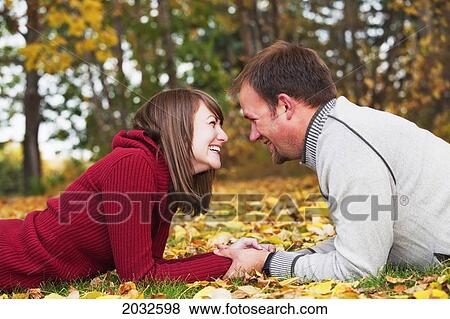 Stock Photo - Young Married Couple Spending Quality Time Together In A Park In Autumn; Edmonton Alberta Canada. Fotosearch