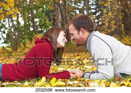 Young Married Couple Spending Quality Time Together In A Park In Autumn; Edmonton Alberta Canada View Large Photo Image Stock Photograph - Young Married Couple Spending Quality Time Together In A Park In Autumn; Edmonton Alberta Canada. Fotosearch