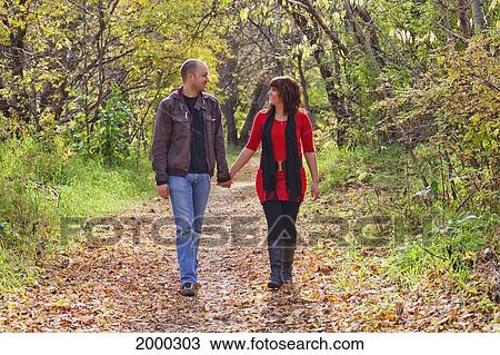 Young Married Couple Walking And Talking Together In A Park; Edmonton Alberta Canada View Large Photo Image Stock Image - Young Married Couple Walking And Talking Together In A Park; Edmonton Alberta Canada. Fotosearch