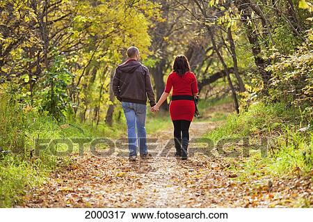 Young Married Couple Walking In A Park In Autumn; Edmonton Alberta Canada View Large Photo Image Stock Photo - Young Married Couple Walking In A Park In Autumn; Edmonton Alberta Canada. Fotosearch